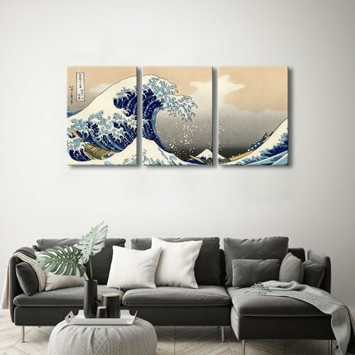 Triptych of The Great Wave off Kanagawa above a gray sofa.