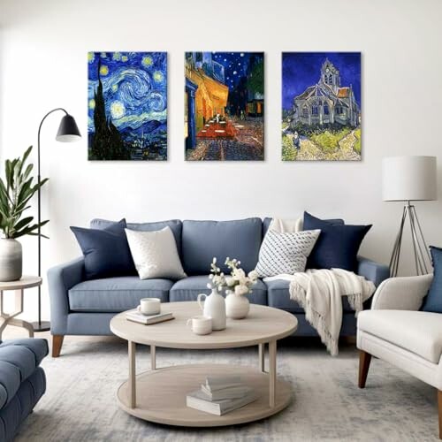 Living room with blue sofas, round coffee table, and Van Gogh paintings on the wall.