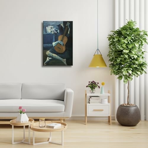 Modern living room with a painting, sofa, and potted plant.