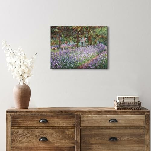Wooden dresser with a painting of a garden above.